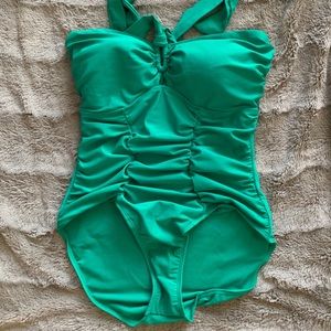Green strapless one piece bathing suit.